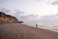 Man walking on remote oman beach exploring coastline Royalty Free Stock Photo