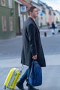 Man walking along a street with his luggage Royalty Free Stock Photo