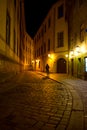 Man walking around the street of the old town at night in Pragu