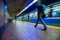 Man walking as a subway train is leaving the station. Royalty Free Stock Photo