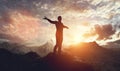 Man walking and balancing on mountain at sunset