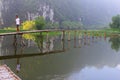 October 2018, Man bamboo pier lake mountains, Ninh Binh, Trang An, Vietnam Royalty Free Stock Photo