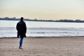 man walking on the beach, photo as a background , in sottomarina, venice, italy Royalty Free Stock Photo