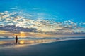 Man walking on beach at sunrise in Florida. Royalty Free Stock Photo