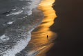 Man walking on the beach at sunset, topshot Royalty Free Stock Photo