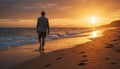 Man walking on beach at sunset Royalty Free Stock Photo