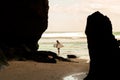 A man walking on the beach with a surfboard. Royalty Free Stock Photo