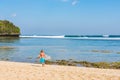 4th September 2019 : Balangan Bali, Indonesia - Man walking on the beach with a surfboard while watching the perfect waves break