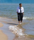 Man walking on beach with waves Royalty Free Stock Photo