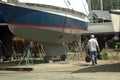 Man walking in boatyard Royalty Free Stock Photo