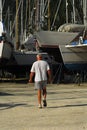 Man walking in boatyard Royalty Free Stock Photo