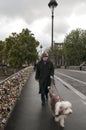 A man walking on the bridge with his dog in Paris Royalty Free Stock Photo