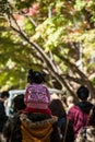 Man walking carrying a little girl on his shoulders