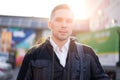 Man walking in city during day, lensflare effect.