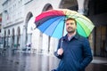 Rainy day in the city and businessman holding umbrella Royalty Free Stock Photo