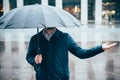 Man walking in the city with umbrella on rainy day Royalty Free Stock Photo