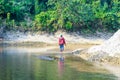 Man walking by the creek in the forest. Hikers hiking in the forest. Hiker walking in a forest beside the mountain river.