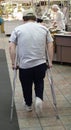 Man walking on crutches in a restaurant