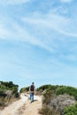 Man walking by a dirt road in Corsica, France