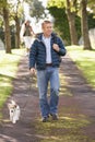 Man Walking Dog In Autumn Park Royalty Free Stock Photo