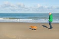 Man walking with dog at the beach Royalty Free Stock Photo