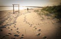 Man Walking Dog on Beach. Footprints in Sand. Royalty Free Stock Photo