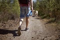 Man walking with dog on footpath in forest Royalty Free Stock Photo