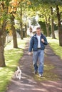 Man Walking Dog Outdoors In Autumn Park Royalty Free Stock Photo