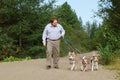 Man Walking Dogs on Trail