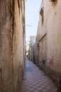 A man walking down an alley in Tripoli, Libya