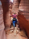 Man walking down narrow canyon