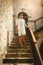 Man walking down the old stone staircase at sunny day Royalty Free Stock Photo