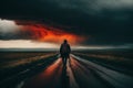 A man is walking down a road in the rain in dramatic weather. A concept of loneliness and depression Royalty Free Stock Photo