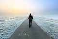 Man walking on an empty desolate raod