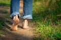 Man walking on footpath forest. Close-up of bare feet soiled with ground. healthy lifestyle. Royalty Free Stock Photo
