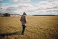 Man walking in grass field in autumn dressed Royalty Free Stock Photo