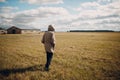 Man walking in grass field in autumn dressed