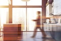 Man walking in gray kitchen with bar Royalty Free Stock Photo