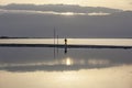 Man Walking On Headland At Early Morning Under Rising Sun