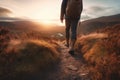 Man walking in hiking boots at unset on a hiking trail. Generative AI