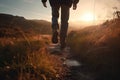 Man walking in hiking boots at unset on a hiking trail. Generative AI