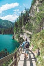 man walking by hiking trail around braies lake in italy dolomites mountains Royalty Free Stock Photo