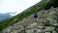 Man walking in hills on path with big bag in tatra mountains Royalty Free Stock Photo