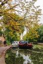 Man walking his dog along Islington Canal in Angel, London.