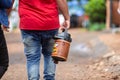 Man walking holding a thermal bottle used to drink traditional chimarrao terere