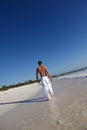 Man walking on idyllic beach