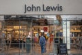 Man walking into John Lewis retail store within the Victoria Quarter complex in Leeds City Centre,UK Royalty Free Stock Photo