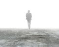 Man walking in mist on dirty concrete floor