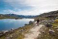 Man walking on a mountain trail in Norway. Path to Trolltunga or Royalty Free Stock Photo