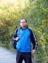 Man walking in nature, middle age tourist enjoying walk in autumn nature